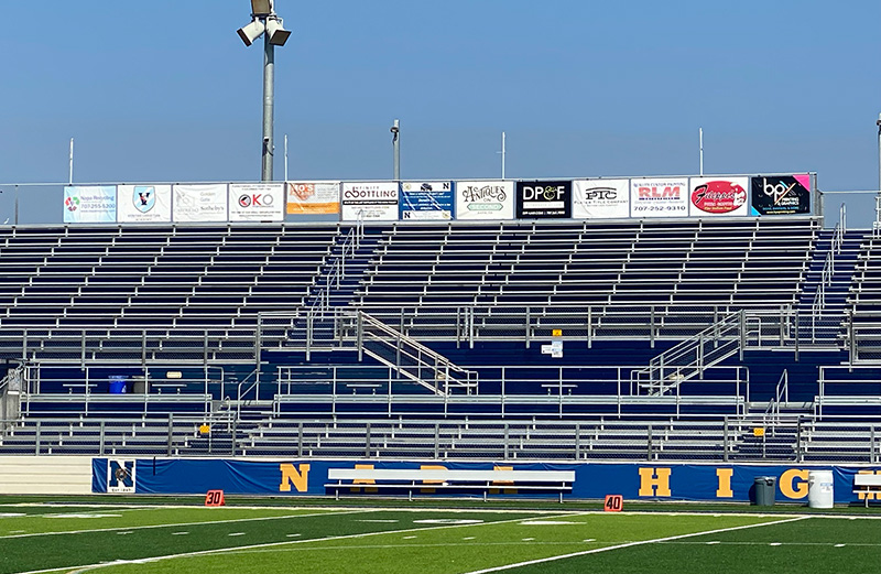 Football field bleachers signs along the top